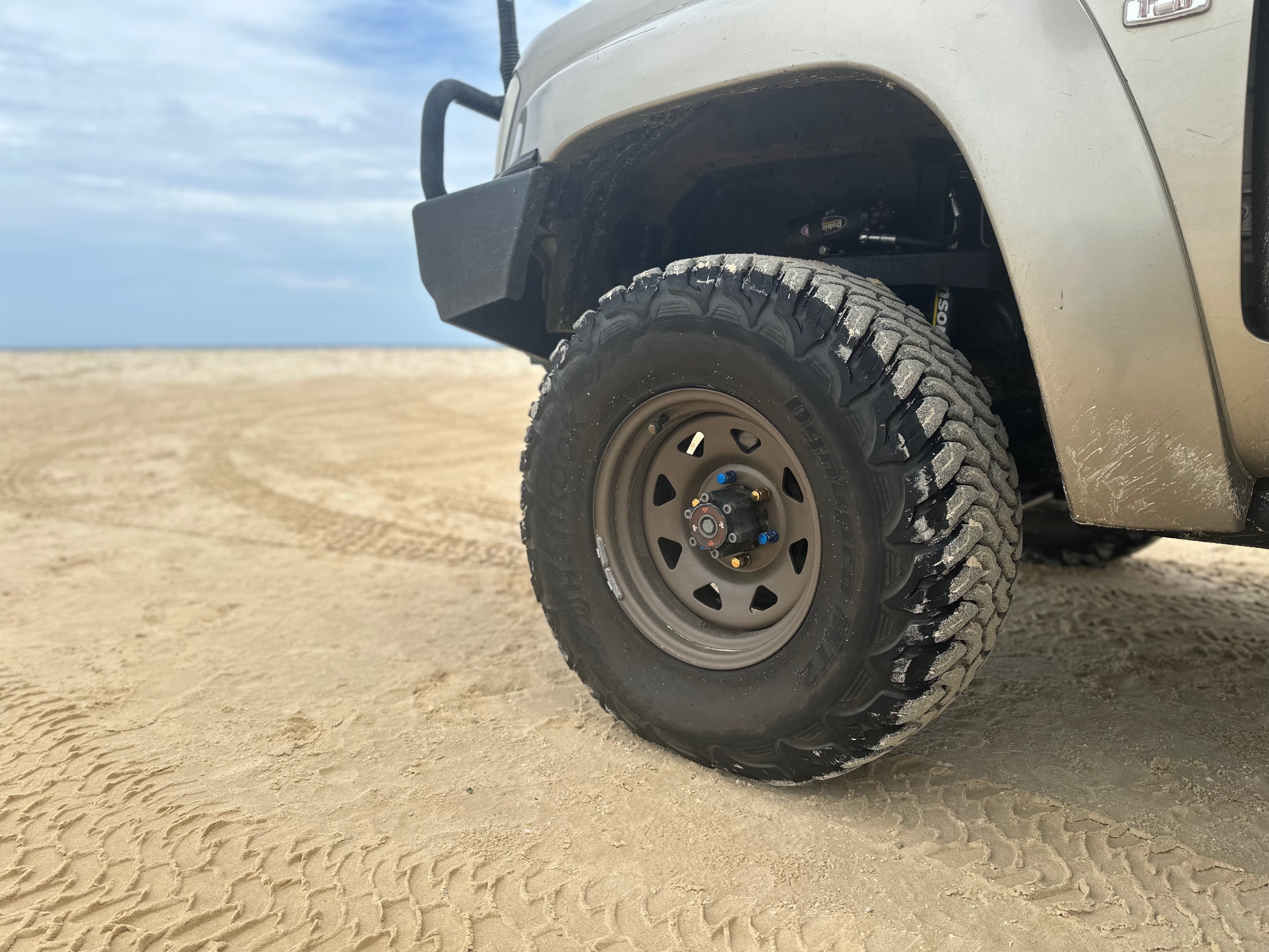 Bronze Steel Wheel on Sandy Beach Looking Beautiful